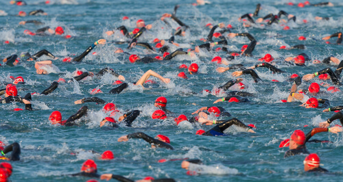 Ironman triathlon swim with lots of hats